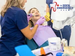 Dentist treating a smiling patient with dental tools, depicting care during a Dental Emergency