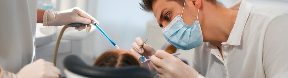 Dentist working on denture repair and relining on patient