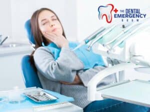 A woman holding her cheek in pain, indicating a broken molar, with dental equipment in the background