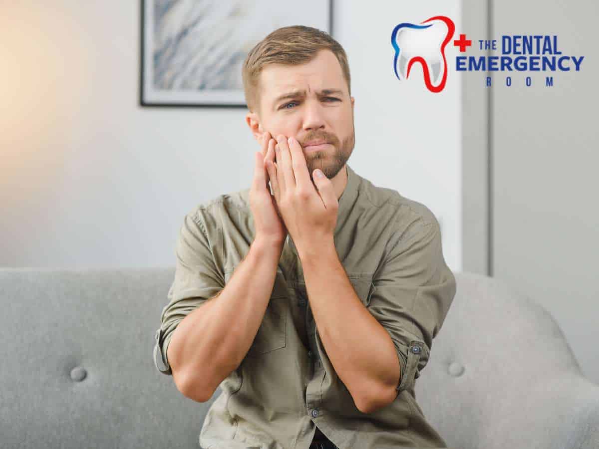  A distressed man clutching his jaw, symbolizing dental abscess pain